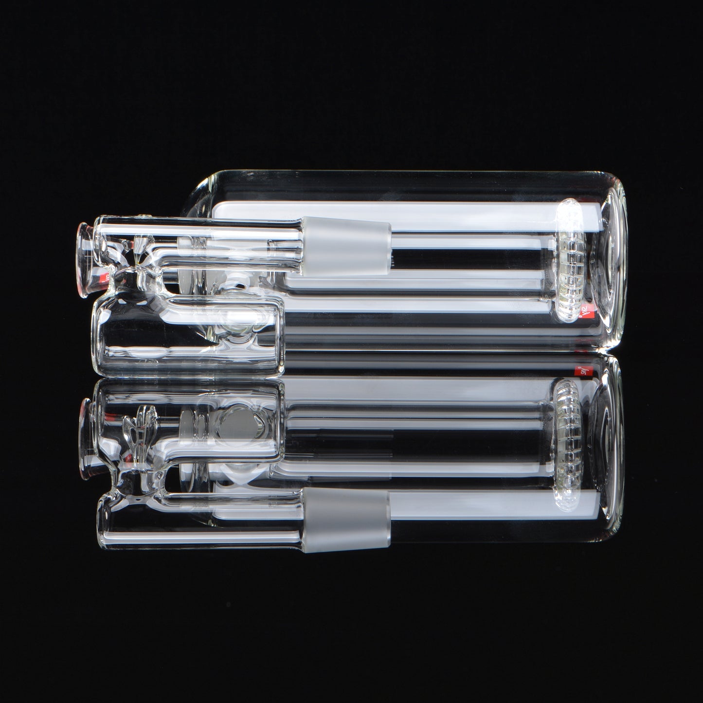 Splashcatcher for a bong laying on its side on a black background