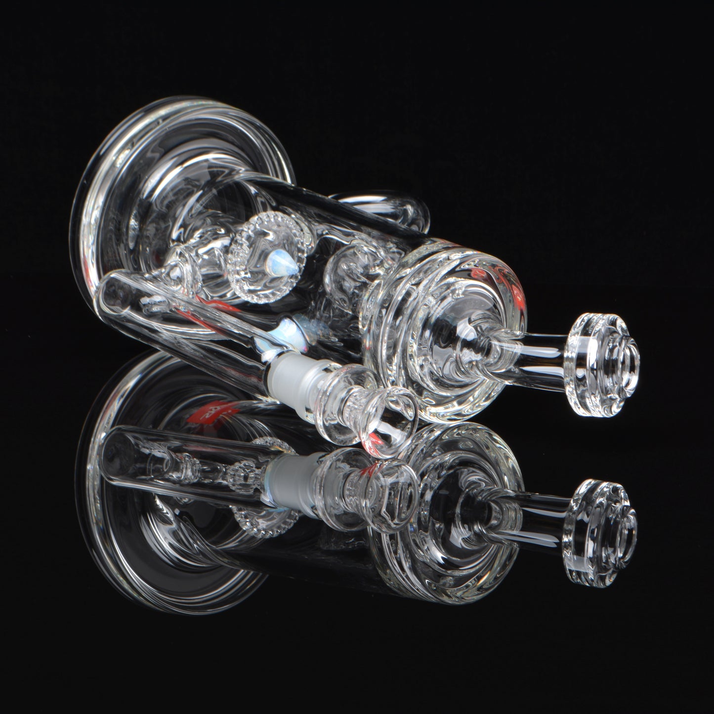 14mm Proton Showerhead Recycler, laying down with a reflection